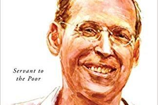 Paul pictured on the cover of the book wearing glasses and smiling