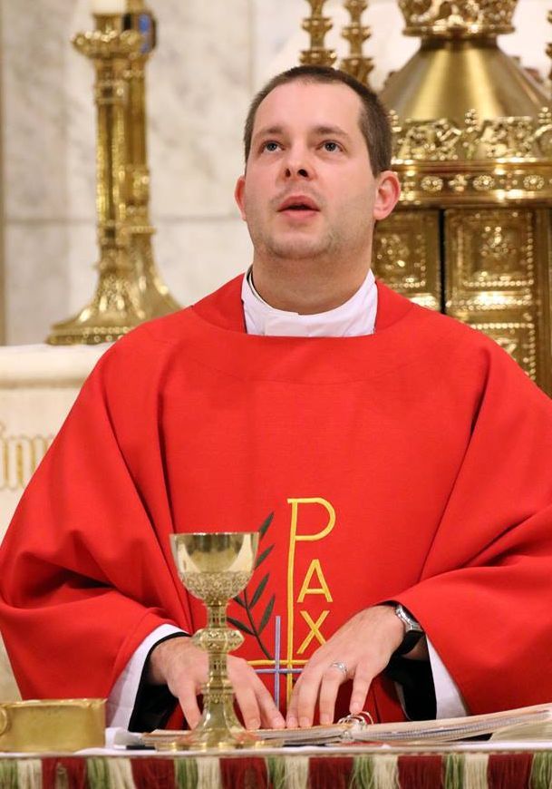 Father Jamie at our 2017 St. Lucy Mass reading braille