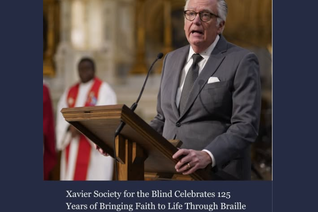 Screenshot of the article showing our Executive Director speaking at the lectern at a past St. Lucy Mass