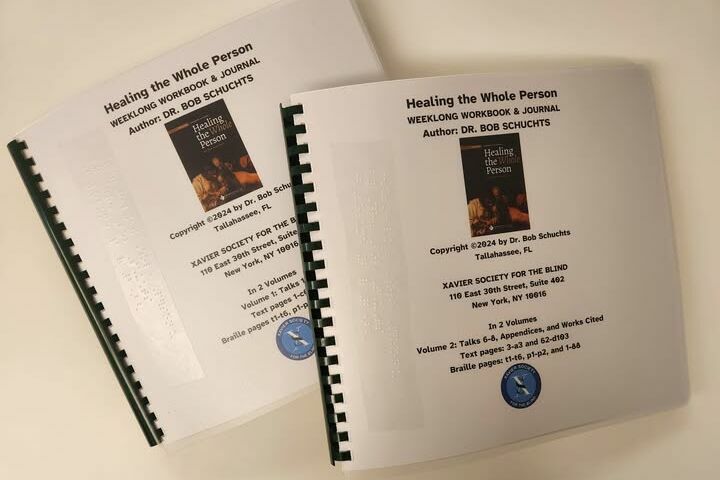 Two volumes of braille standing upright on the counter
