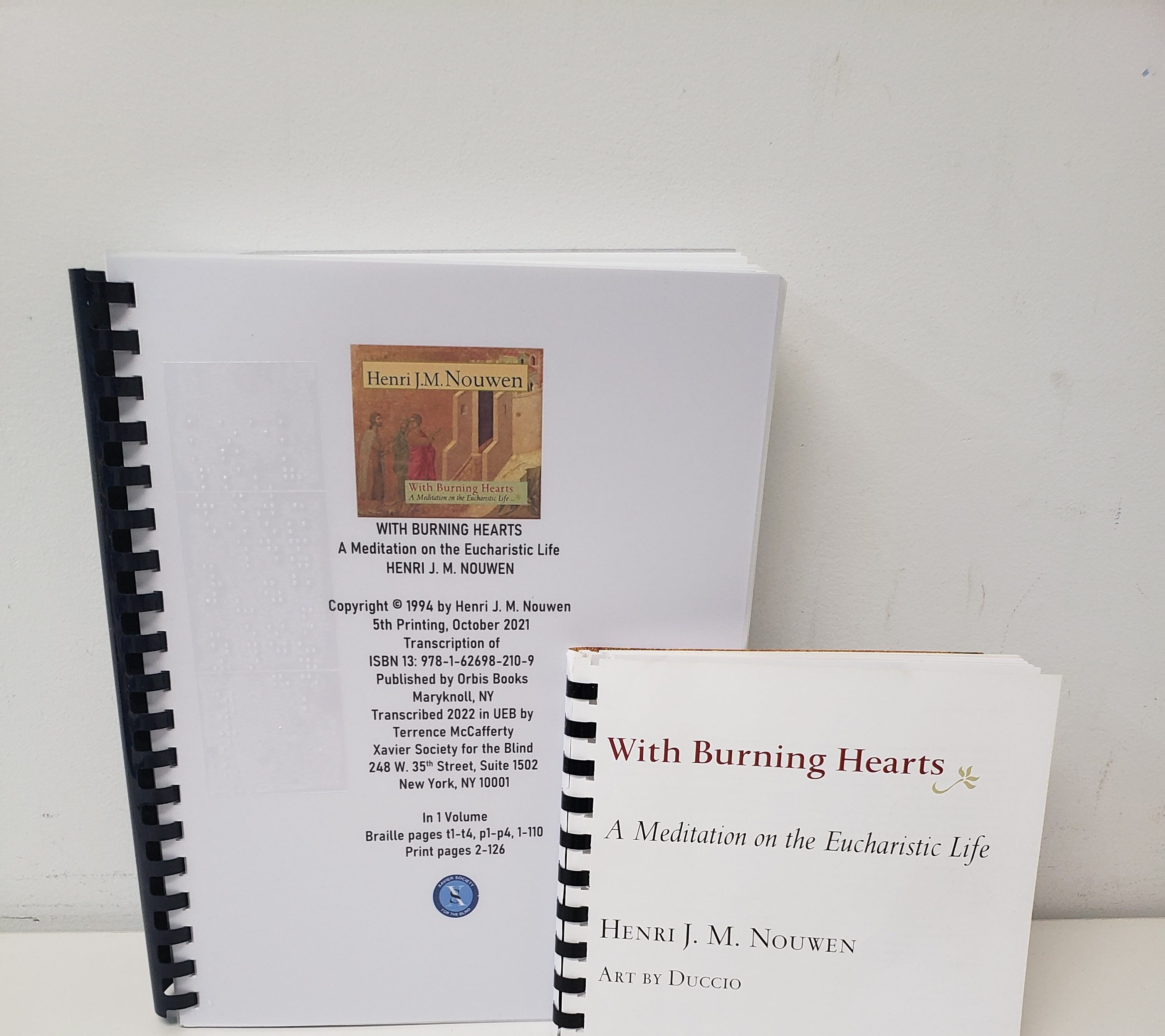 With Burning Hearts pictured in braille and print