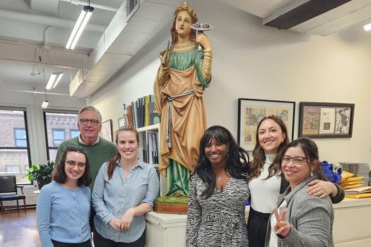 The ladies from Catholic Charities New York pictured with XSB staff and St. Lucy