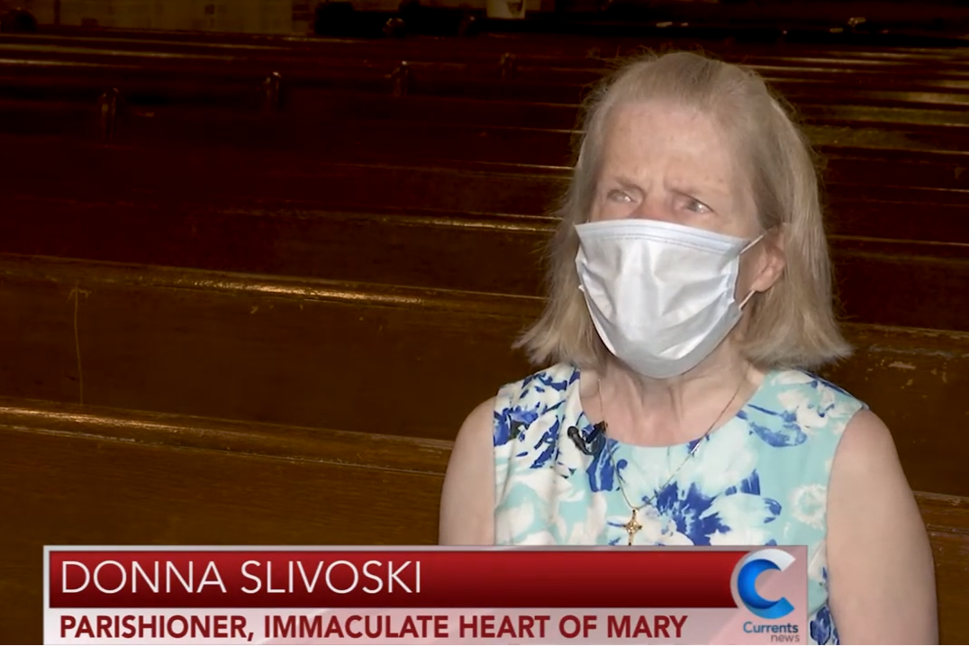 Donna pictured in her church wearing a mask and blue dress