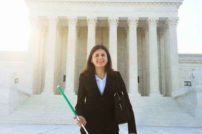 Laura pictured outside the Supreme Court on a sunny day.