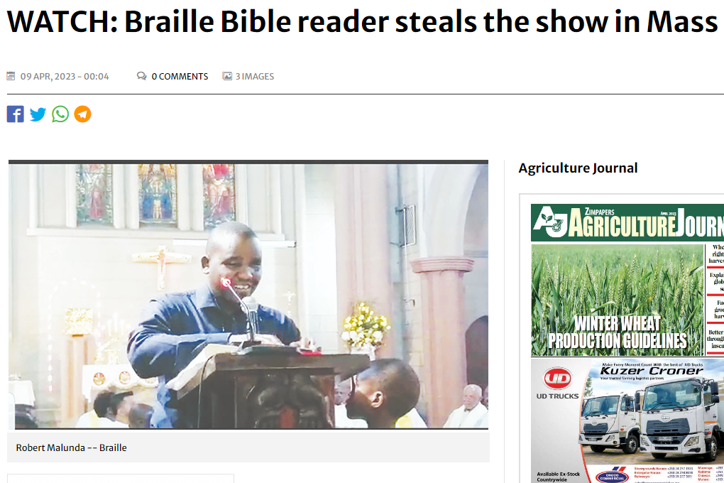Screenshot of the article showing Robert smiling while reading braille