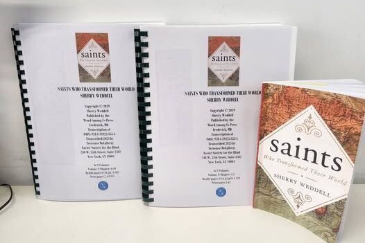 two volumes of braille with print version of the book