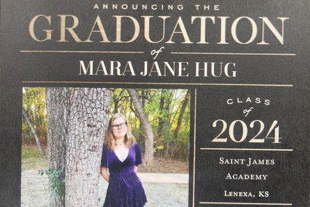 Our braille patron Mara, a teenager with blonde hair and glasses, pictured in her back yard against a tree