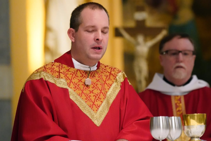 Father Jamie deep in prayer as Father Denis Donoghue looks on