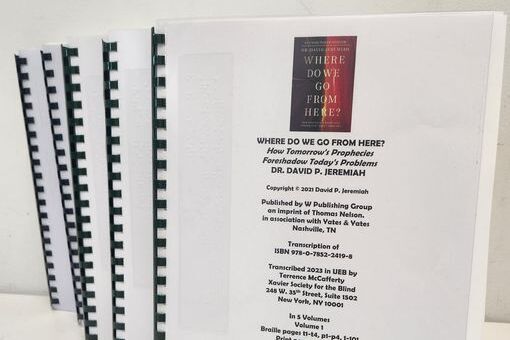 5 volumes of braille stacked on the counter